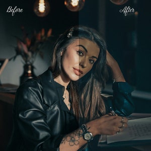 May include: A woman wearing a black leather jacket sits at a table, writing in a notebook. She has long dark hair and is wearing a watch on her left wrist.