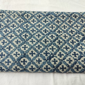 May include: A blue and white kantha quilt with a geometric pattern. The quilt is made of cotton and is hand-stitched.