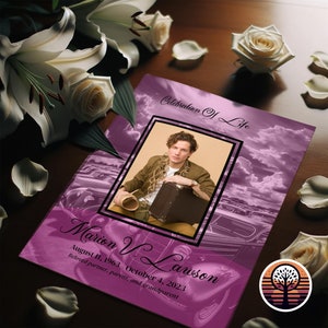 May include: A purple and white memorial booklet with a photo of a man in a brown shirt and a suitcase. The text on the cover reads "Celebration of Life" and "Marion V. Lawson August 11, 1963 October 4, 2023 Beloved partner, parent, and grandparent".