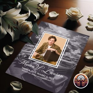 May include: A black and white photo of a man in a brown jacket and a suitcase. The photo is on a black and white background with a vintage car and clouds. The text "Celebration of Life" and "Marion V. Lawson" is on the photo. The dates "August 11, 1963 - October 4, 2023" and "Beloved wife, mother and grandmother" are also on the photo.