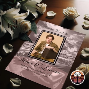 May include: A pink and white memorial card with a photo of a man in a brown jacket and a suitcase. The text on the card reads "Celebration of Life" and "Marion V. Lawson August 11, 1963 - October 4, 2023 Beloved wife, mother and grandmother".