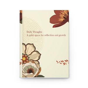 May include: A hardback journal with a cream-coloured cover featuring a floral design in shades of rust, brown, and muted green. The text on the cover reads: Daily Thoughts, A quiet space for reflection and growth. A dotted pattern accents the left side.