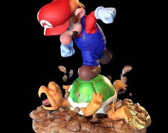 May include: A red and blue figurine of Mario stomping on a green turtle shell. The turtle shell is on a brown base with brown rocks and dirt.