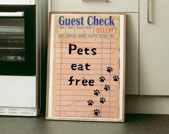 May include: A white kitchen with a sign that says "Guest Check 051197 Pets eat free" with paw prints.