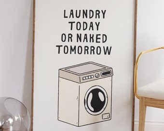 May include: A framed print with a white background and black text that reads "Laundry Today or Naked Tomorrow". A cartoon illustration of a beige washing machine is below the text.