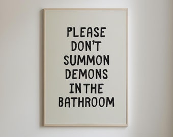 May include: A white framed sign with black text that reads "Please don't summon demons in the bathroom."