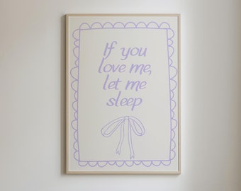 May include: A framed print with a white background and a purple text overlay that reads "If you love me, let me sleep". The text is surrounded by a decorative border with scalloped edges. A purple ribbon bow is drawn below the text.