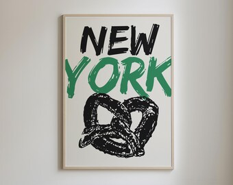 May include: A framed print with the words "NEW YORK" in black and green lettering, with a black and white pretzel illustration below the text.