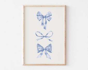 May include: A framed print with three blue watercolor bows. The bows are arranged vertically in a simple design.