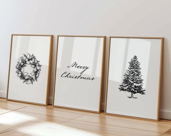 May include: Three framed prints with a Christmas theme. The left print features a black and white illustration of a wreath. The middle print features the text "Merry Christmas" in black script. The right print features a black and white illustration of a Christmas tree.
