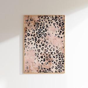 May include: A framed abstract art print with a pink and black leopard print pattern.