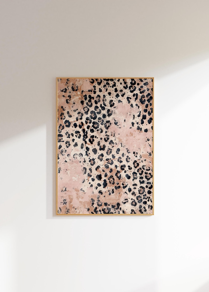 May include: A framed abstract art print with a pink and black leopard print pattern.