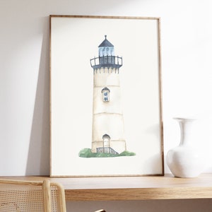 May include: A watercolor painting of a white lighthouse with a black roof and a blue window. The lighthouse is on a green grassy hill.
