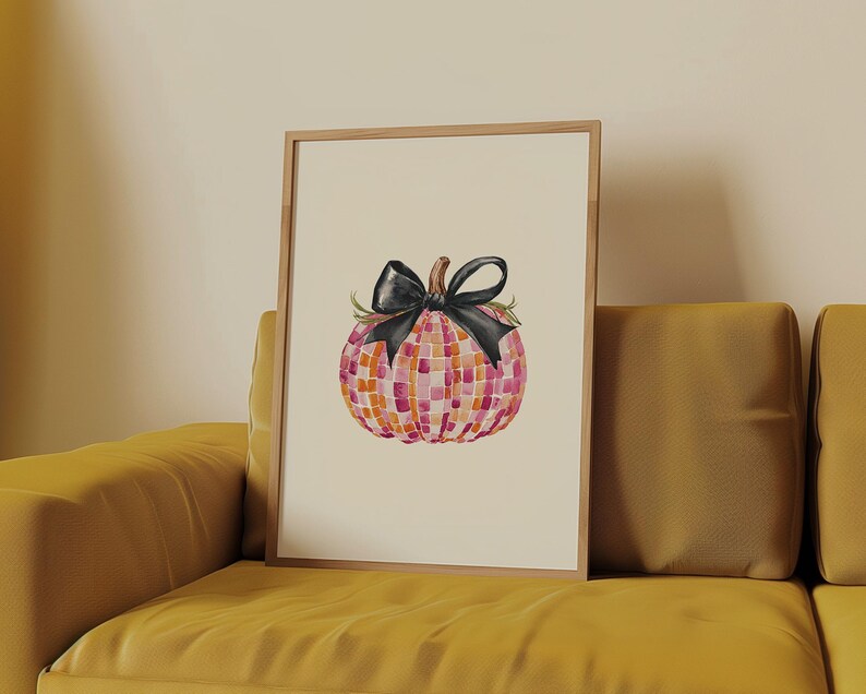 May include: A watercolor painting of a pink and orange mosaic pumpkin with a black bow. The pumpkin is sitting on a white background.