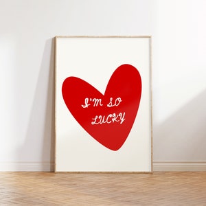May include: A red heart with the text "I'm so lucky" in white lettering on a white background.