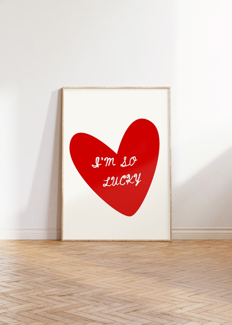 May include: A red heart with the text "I'm so lucky" in white lettering on a white background.