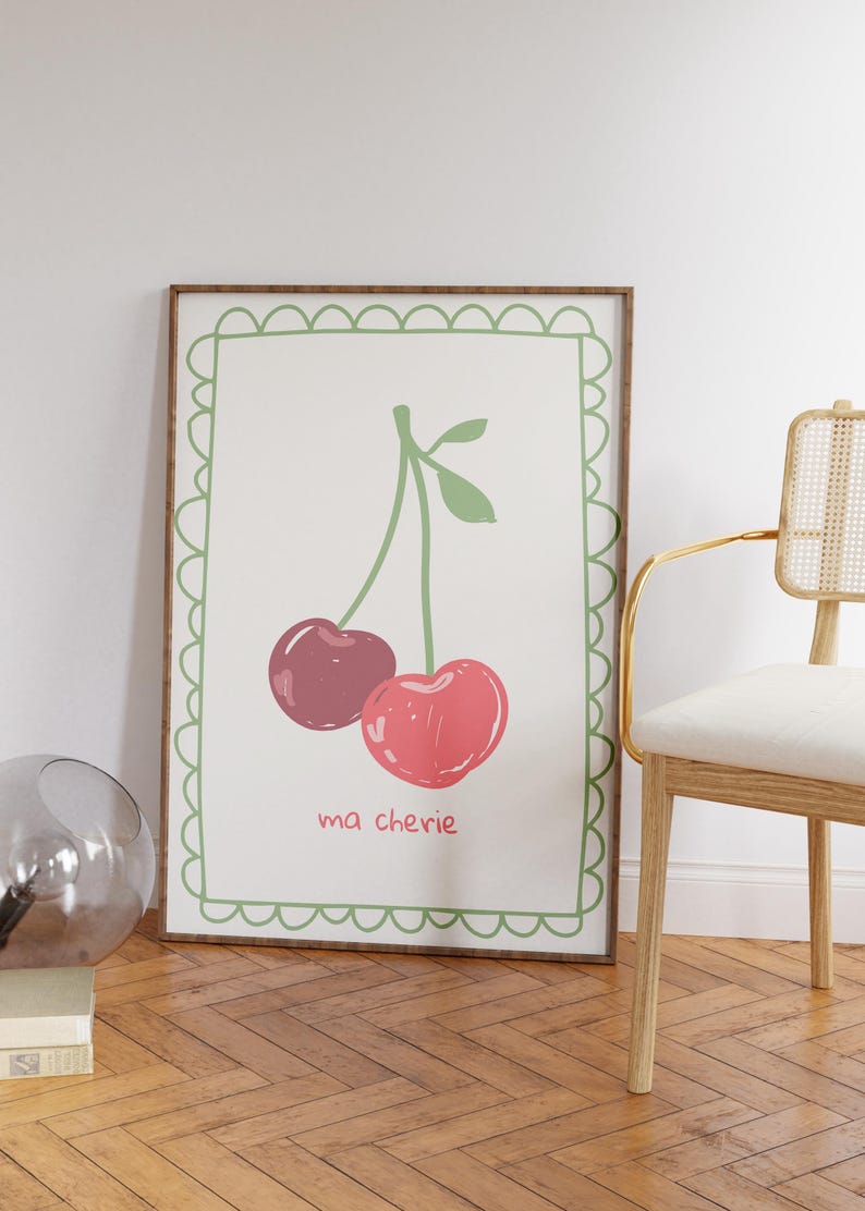 May include: A framed print with a green border and a white background. The print features a drawing of two red cherries on a green stem with the text "ma ch&eacute;rie" below.