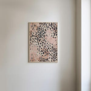 May include: A framed print with a pink and black leopard print pattern.