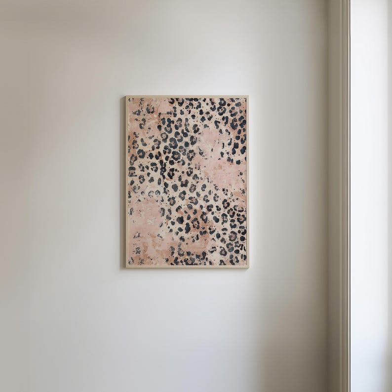 May include: A framed print with a pink and black leopard print pattern.