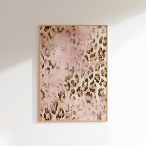May include: A framed abstract art print with a pink background and a brown leopard print pattern.