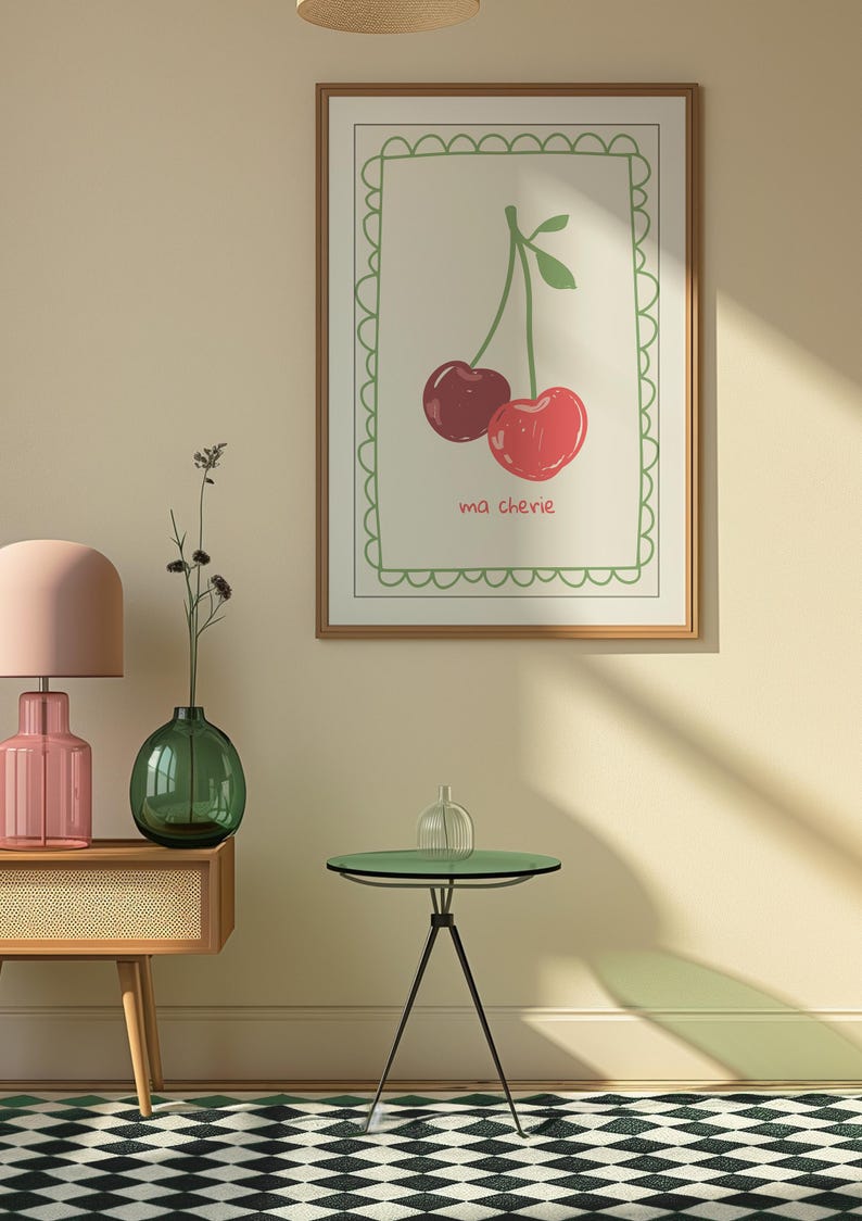 May include: A framed print with a green border and a white background. The print features a drawing of two red cherries with green stems and leaves. The text "ma ch&eacute;rie" is written below the cherries.