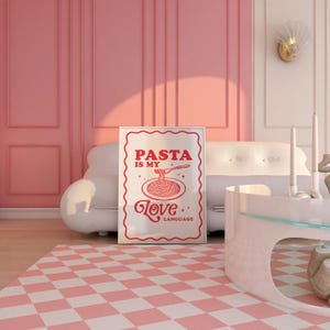 May include: A white poster with a red border and red text that says "PASTA IS MY LOVE LANGUAGE" with a drawing of a plate of spaghetti and a fork. The poster is hanging on a pink wall.
