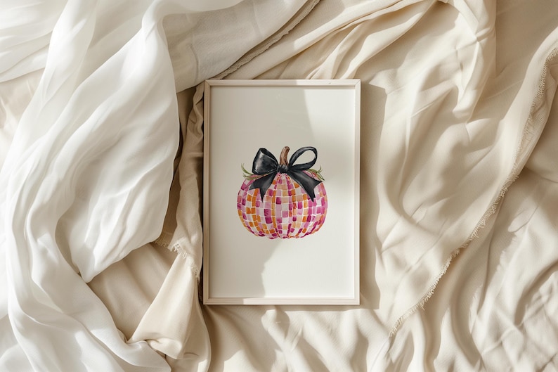 May include: A framed watercolor painting of a pink and orange pumpkin with a black bow. The pumpkin is decorated with a mosaic pattern.