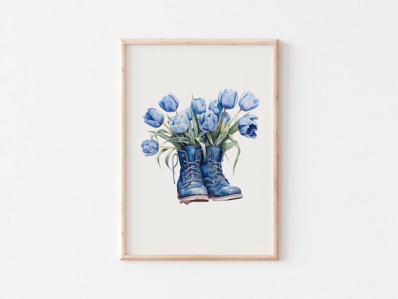 In a frame on the wall is a picture of a bouquet of spring blue tulips standing in vintage dark blue boots (digital image).