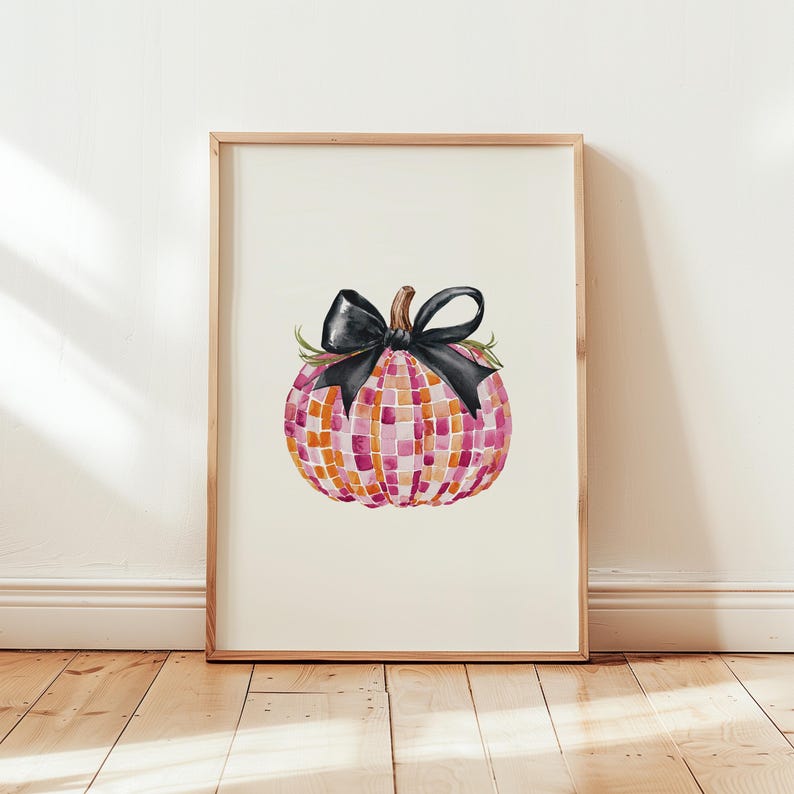 May include: A watercolor painting of a pink and orange checkered pumpkin with a black bow. The pumpkin is sitting on a white background.