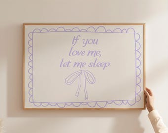 May include: A framed print with a white background and a purple border. The print features the text "If you love me, let me sleep" and a purple illustration of a bow.