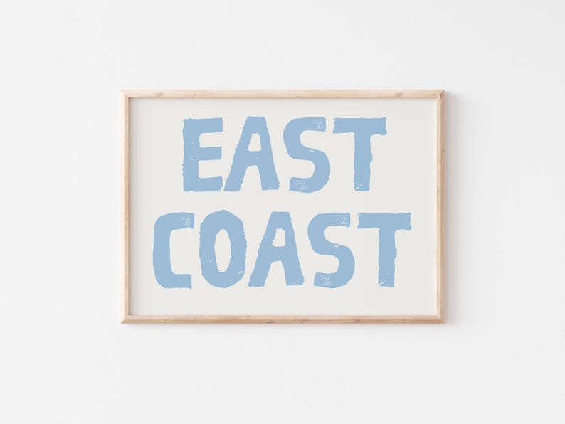 May include: A framed print with the text "EAST COAST" in a light blue color on a white background.