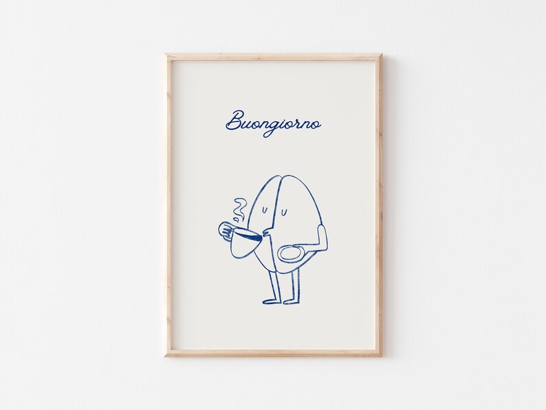 Peut inclure: Une impression encadr&eacute;e avec une illustration bleue d'un personnage en forme de grain de caf&eacute; tenant une tasse de caf&eacute; et une assiette. Le texte "Buongiorno" est &eacute;crit en cursive bleue en haut de l'impression.