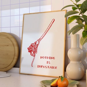 May include: A white framed print with a red illustration of a fork with spaghetti on it. The text "NOTHING IS IMPASTABLE" is written below the illustration.