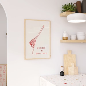 May include: A framed print with a red illustration of spaghetti and the text "Nothing is Impassable".