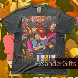 May include: Dark gray t-shirt featuring a colorful collage of cartoon characters. The graphic includes a man holding a dog, a woman in pink, and the text "DISPATCH" and "ExsanderGifts" in white. The shirt is made of Comfort Colors material.