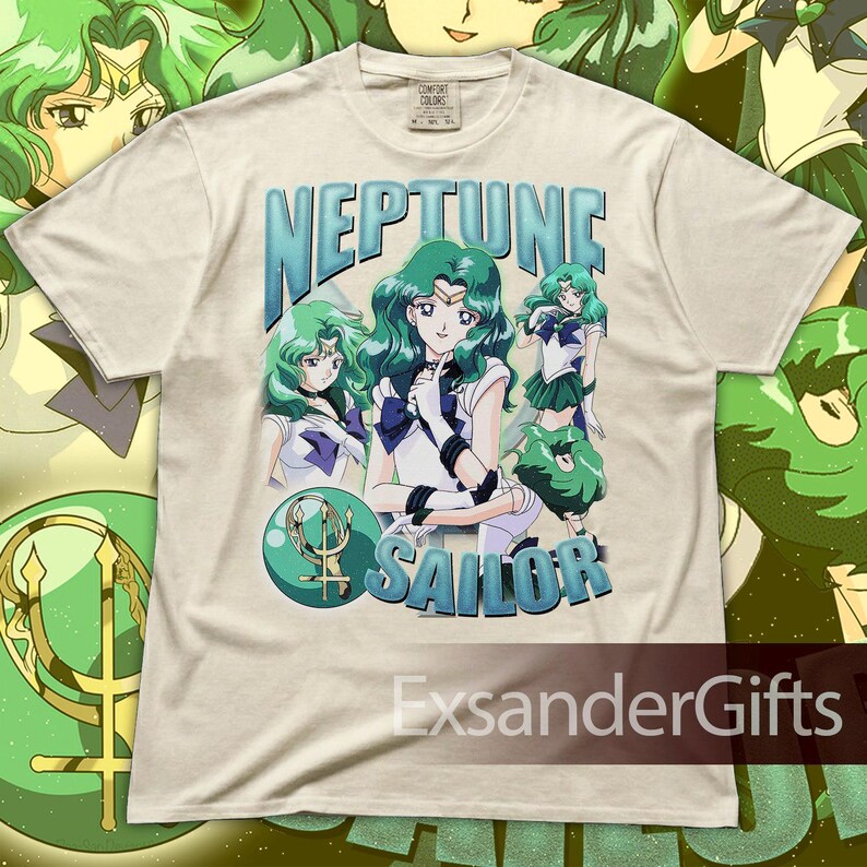 May include: Cream-colored t-shirt featuring a graphic of the character Sailor Neptune from the anime series Sailor Moon. The design includes the text "NEPTUNE SAILOR" in blue, along with multiple illustrations of the character. The shirt has a Comfort Colors tag.