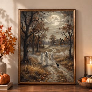 May include: A framed wall art print depicting a moonlit autumn forest scene with three translucent white ghost figures walking along a dirt path toward a house. A small black cat walks beside them amidst dry grass, fallen leaves, and bare trees.