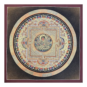 May include: A circular mandala painting with gold and silver accents on a black background. The central figure is a deity with a crown and ornate clothing, surrounded by intricate patterns and symbols.