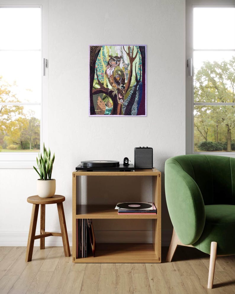 Textile owl artwork displayed as woodland-inspired wall decor in a cozy living room or study.