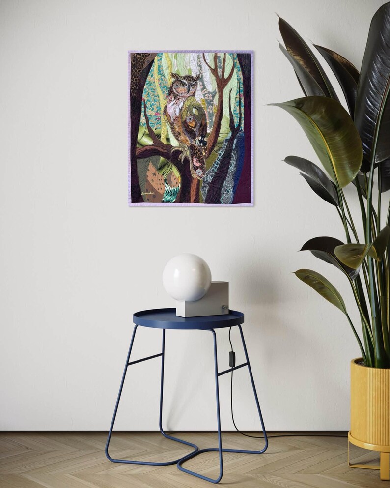 Textile owl artwork displayed as woodland-inspired wall decor in a cozy living room or study.