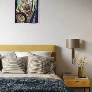 Textile owl artwork displayed as woodland-inspired wall decor in a cozy living room or study.
