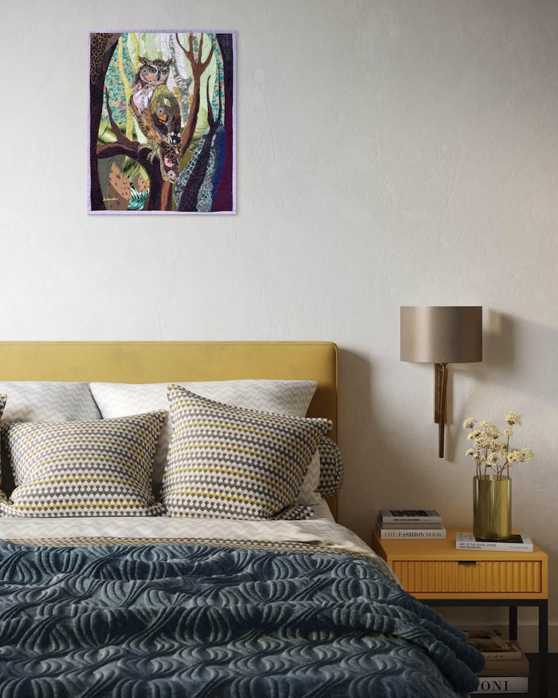 Textile owl artwork displayed as woodland-inspired wall decor in a cozy living room or study.