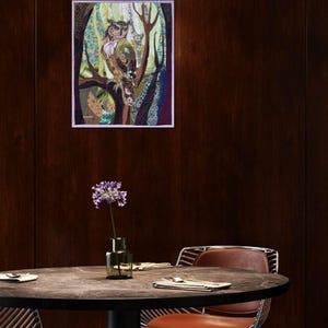 Textile owl artwork displayed as woodland-inspired wall decor in a cozy living room or study.