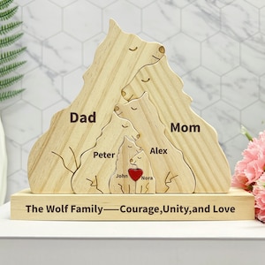 May include: Wooden cutout of a wolf family with the words "Dad", "Mom", "Peter", "Alex", "John", and "Nora" inscribed on each wolf. The base of the cutout reads "The Wolf Family - Courage, Unity, and Love".
