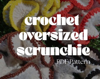May include: Three crocheted oversized scrunchies in different colours. The scrunchies are made with a white yarn and have a contrasting coloured border. The colours are yellow, red, and brown. The scrunchies are on a bed of green grass. The text "crochet oversized scrunchie PDF Pattern" is on the image.