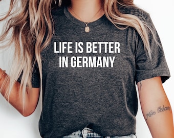 May include: A dark gray t-shirt with the text "Life is better in Germany" printed in white.