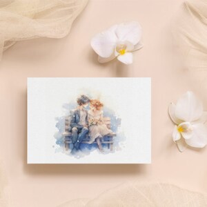 Romantic card display with watercolor couple art and white orchids on a soft peach background.