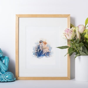 Framed watercolor couple illustration, complemented by a serene Buddha statue and fresh flowers.