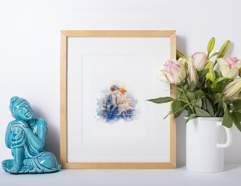 Framed watercolor couple illustration, complemented by a serene Buddha statue and fresh flowers.