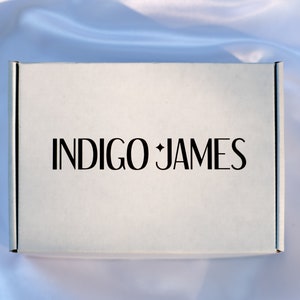 May include: A white box with the text "INDIGO JAMES" printed in black.